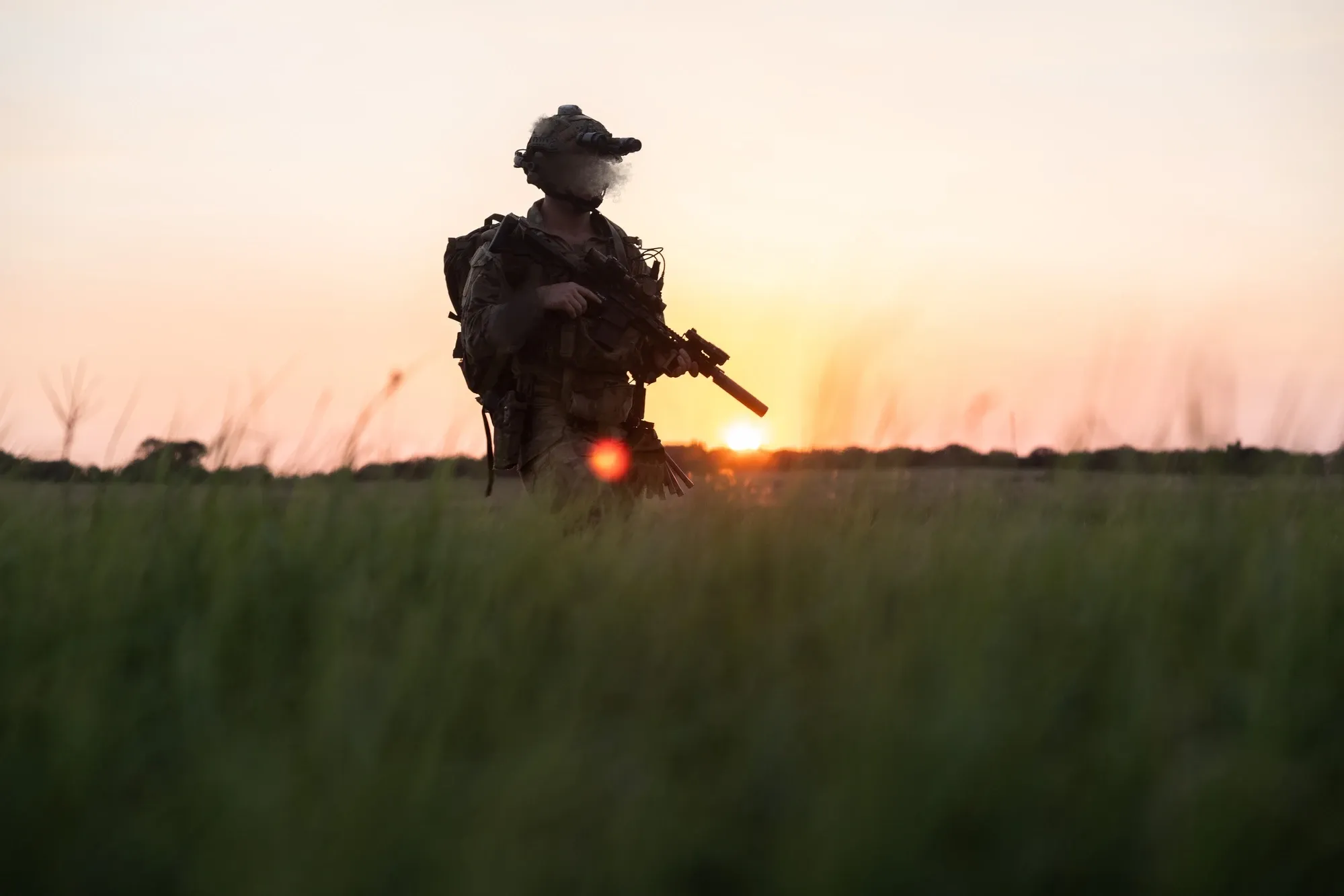 A MARSOC critical skills operator patrolling alongside MARSOC and AFSOC explosive ordnance disposal technicians during pre-deployment primer training